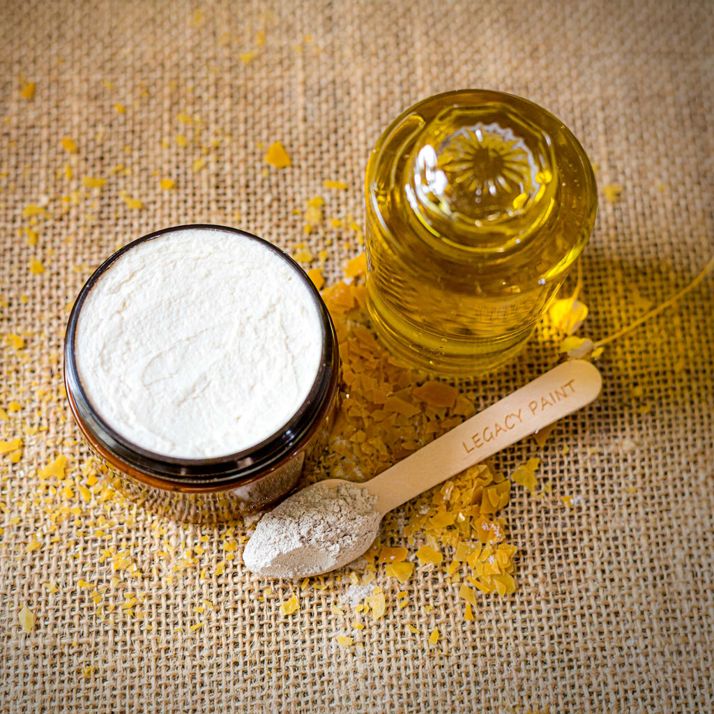 Legacy Paint Encaustic Composition: Open jar of mineral wax and natural resins alongside Spanish olive oil and raw Spanish White (calcium carbonate). A fidedign visual of our Spanish artisan matter, showcasing the unrefined elements used for bespoke furniture curation and historical surface reinterpretation